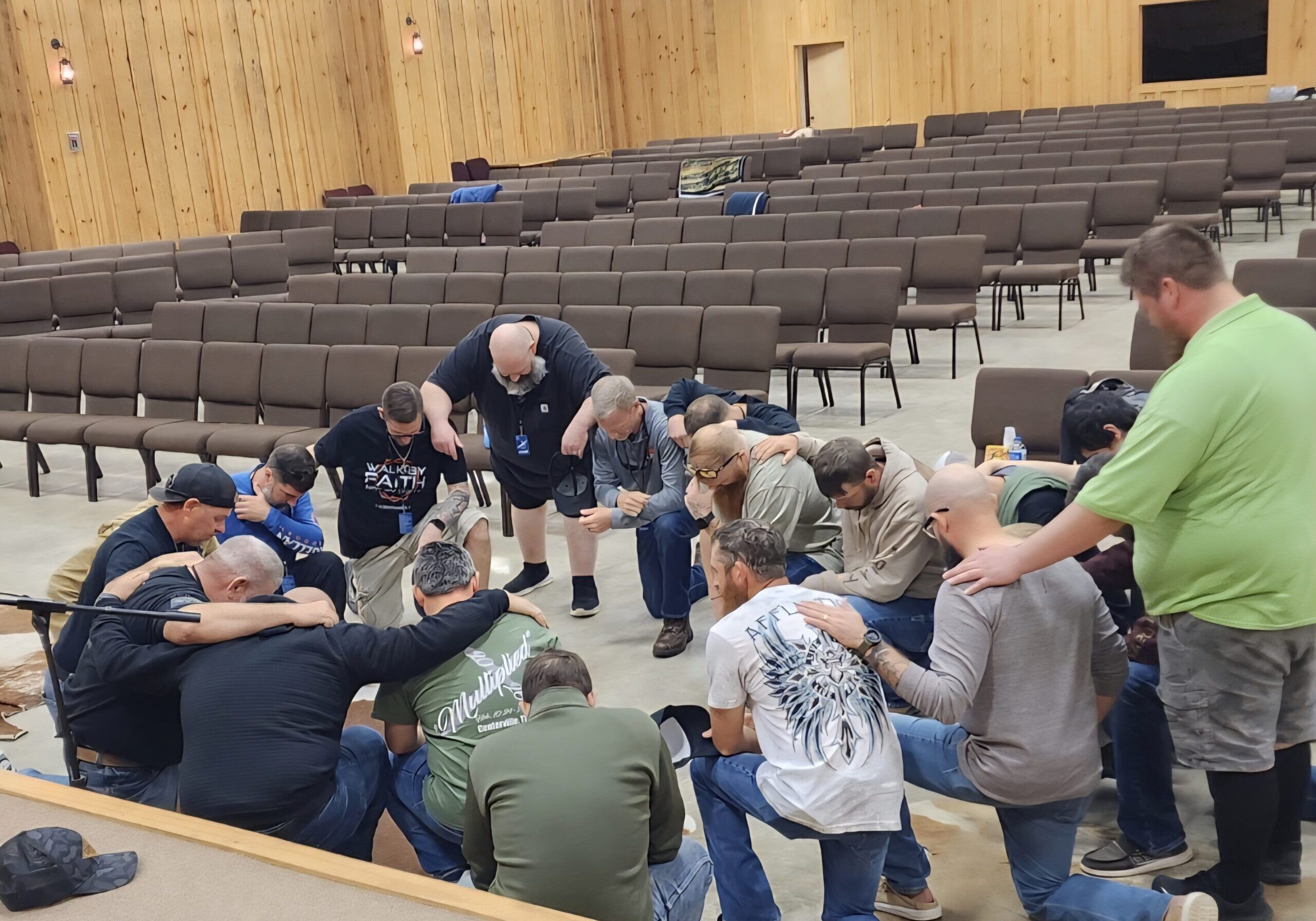 Men gathered together in prayer